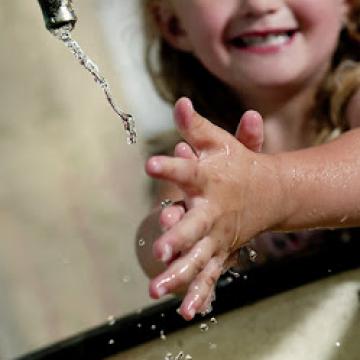 Child washing her hands