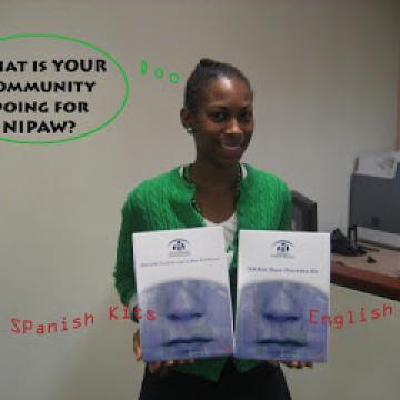 Girl holding NIPAW pamphlets